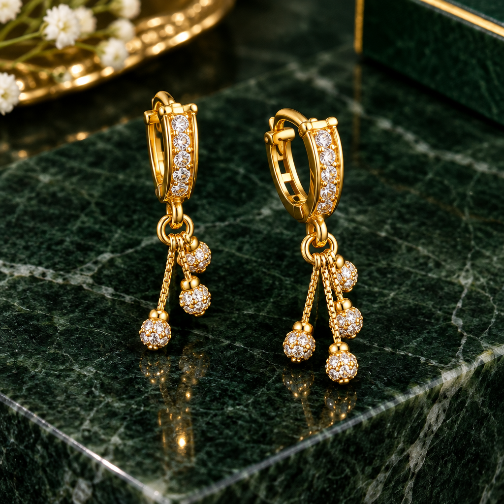 Gold plated drop earrings dark green marble background