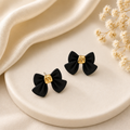 Black bow earrings white ceramic tray dried flowers