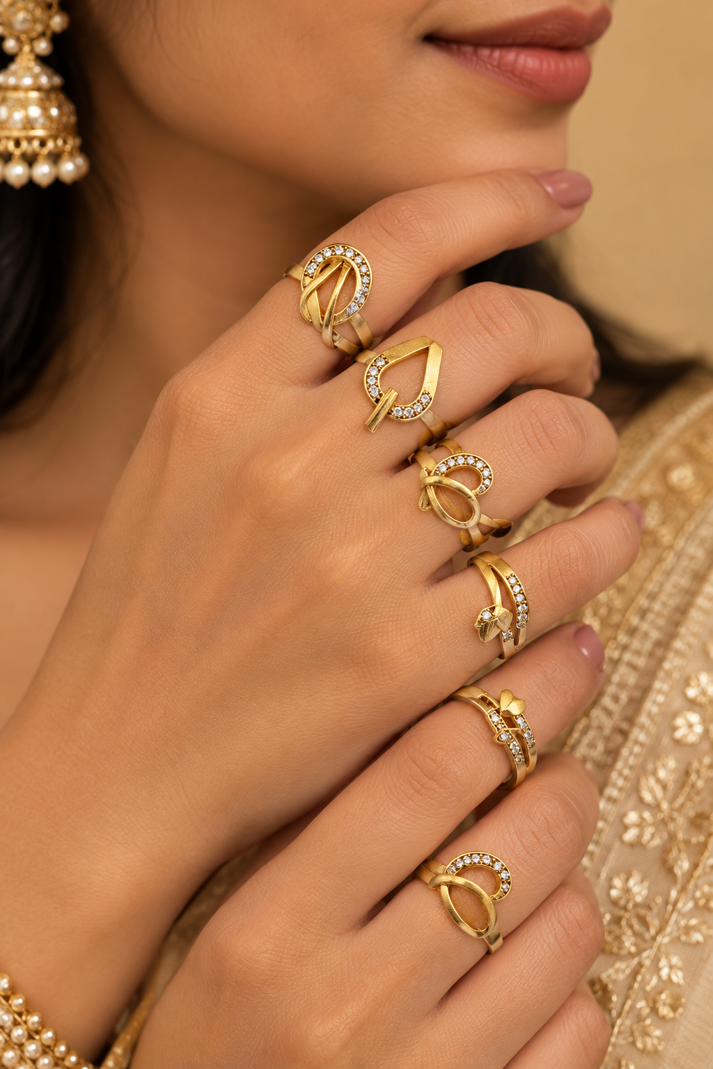 Gold plated rings stacked on model fingers