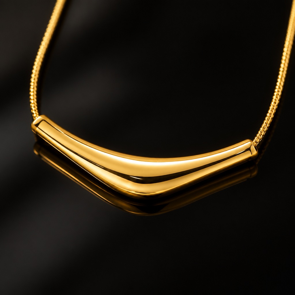 Gold curved bar necklace close-up black glossy