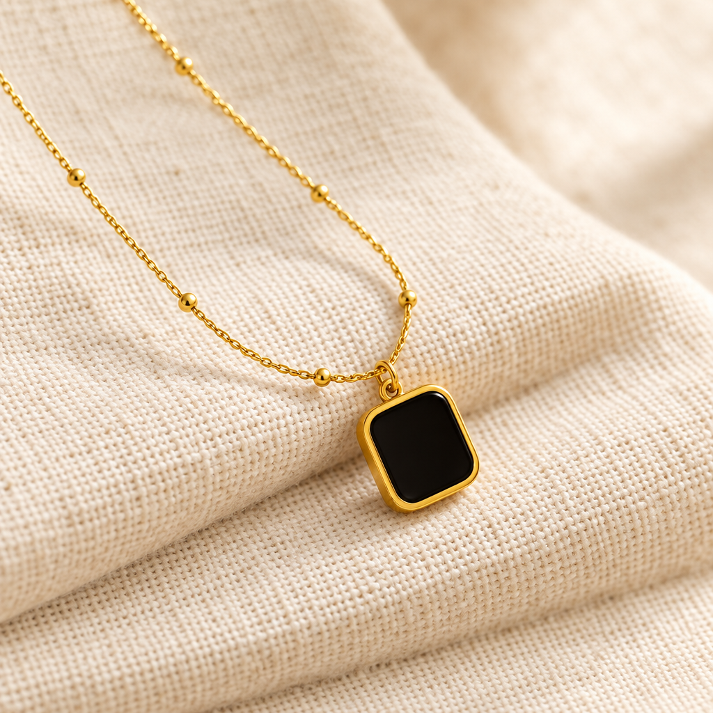 Black square pendant necklace close-up cream linen
