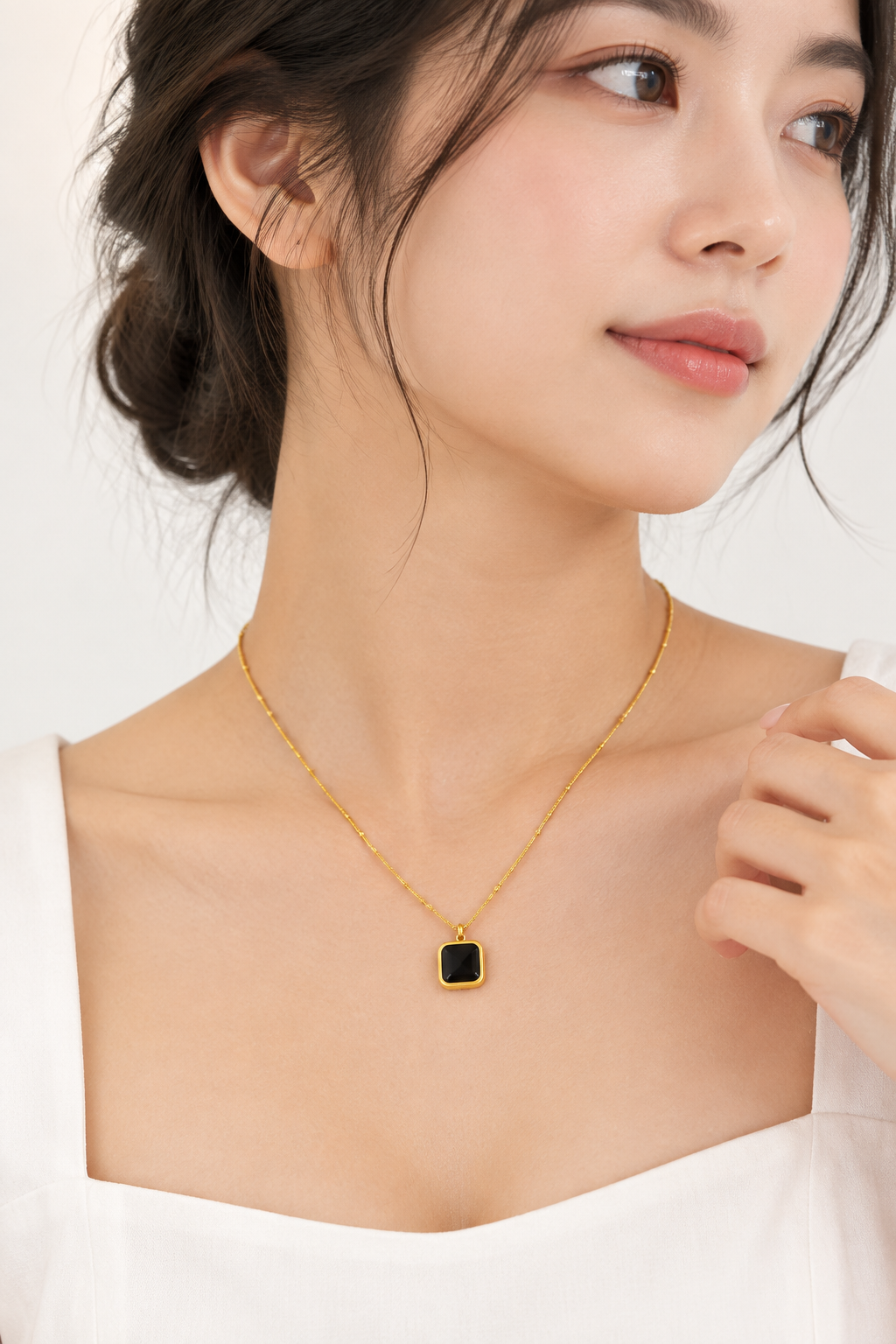 Black square pendant necklace on model white background