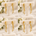 Gold plated drop earrings cream white background